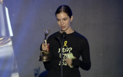 Filmmaker Tom Nesher at Ophir Awards on September 16, 2024, where she received the award for the best feature film, wearing a t-shirt that refers to the remaining 101 hostages held by Hamas in Gaza. (Courtesy)
